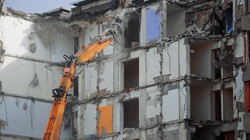 Dismantling the destroyed roof of a high building.