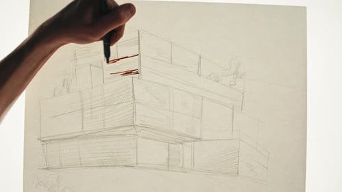 Young Man Artist is Drawing Buildings By Pencil on White Paper Top View The Architect Making