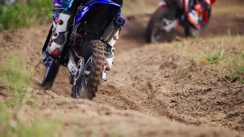 Motocross Racers Passing Curve Sand Dirt Road in slow motion