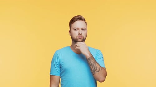 Thinking Young Man Over Vibrant Background Studio Portrait of Expressive Handsome Person