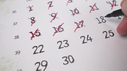 Marking Dates Off on Calendar with Pen