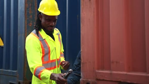 Worker Repairs Shipping Container with Welding Torch