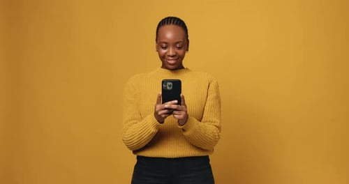Woman Smiling While Using Cell Phone