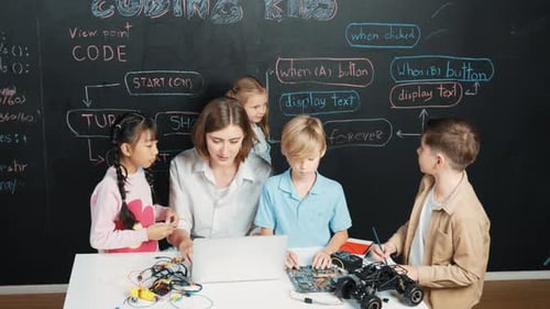 Diverse student writing engineering code while boy fixing board. Erudition.