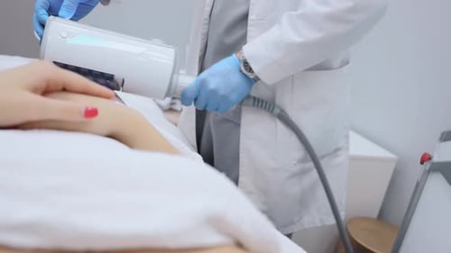 Woman Receives Leg Treatment in Medical Clinic