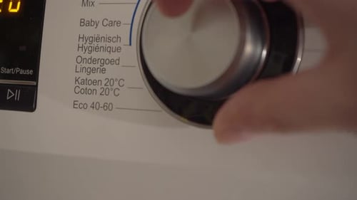 Narrow focus close-up: Dutch laundry washer dial turned to eco setting
