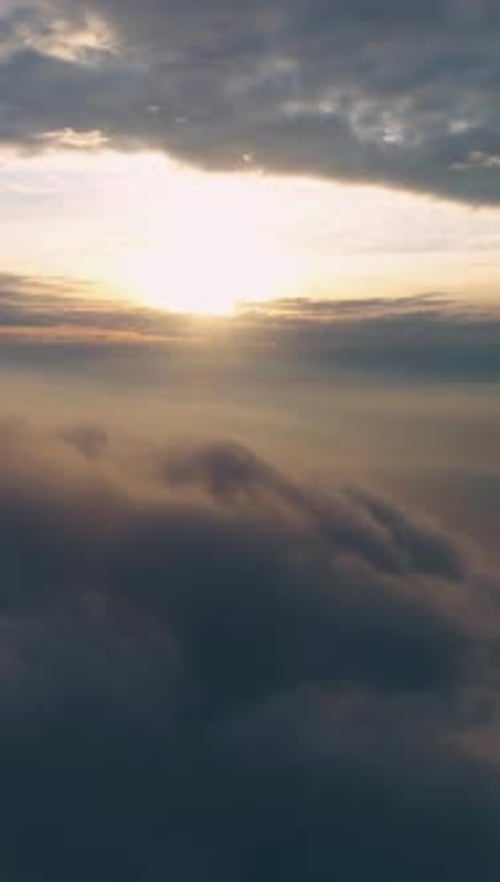 Aerial View of Sunrise Above the Clouds