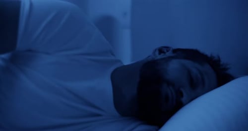 Man Sleeping Peacefully in Bed at Night