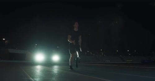 Cinematic close up of young disable man with legs prosthesis launching off the start line with rac