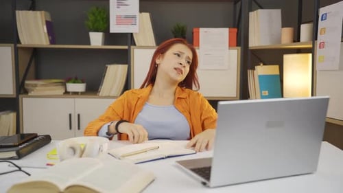 Frustrated Woman Working at Desk with Laptop
