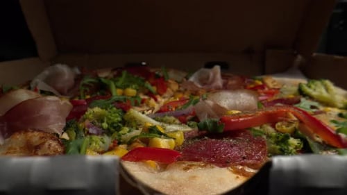 Close Up of Pizza with Prosciutto and Arugula