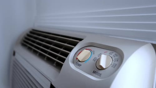 Close Up of a Wall Mounted Air Conditioner Control Panel Adjustable Temperature and Mode Settings on