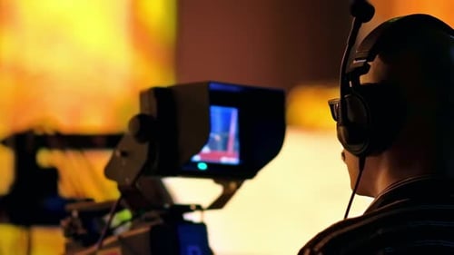 Cameraman Behind Professional Video Camera in Broadcast Setting