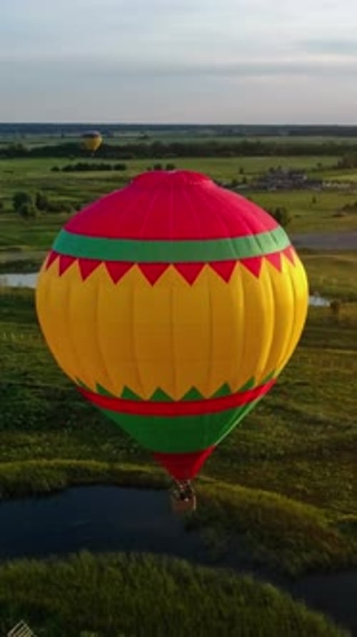 Colorful Hot Air Balloon Over Rural Landscape