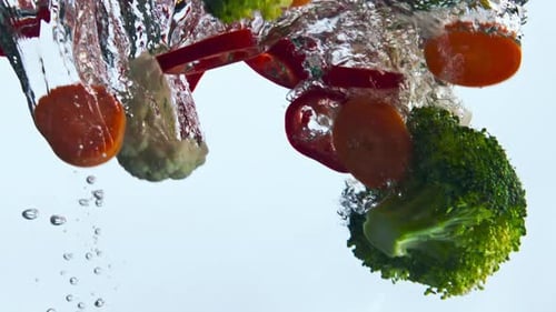 Ripe Tasty Vegetables Splashing Bubbling Clear Water in Super Close