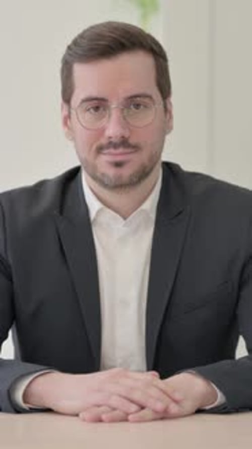 Businessman Looking at the Camera in Office, vertical video
