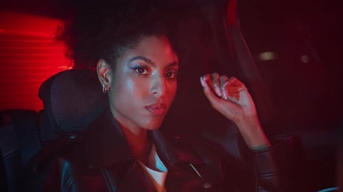 Stylish Woman Posing in Car at Night