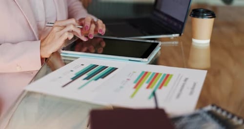 Woman Works on Tablet at Office Desk