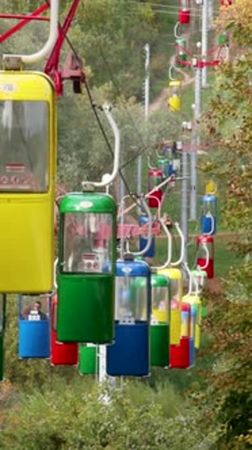 Colorful cableway cabins in autumn city park