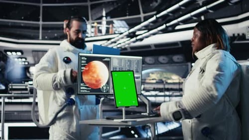 Astronauts Reviewing Onboard Analytics on Isolated Screen Tablet