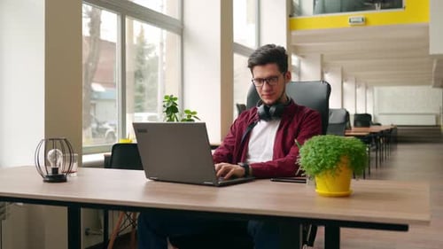 Camera Flies Around Developer Writing Program Code on Computer Display Alone in Office Freelancer