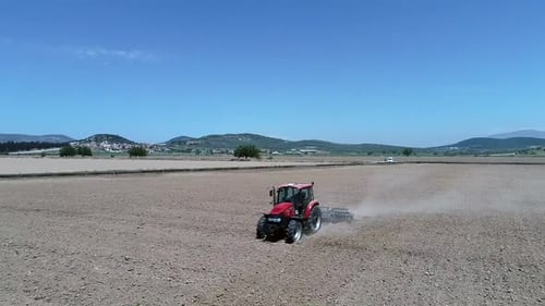 tractor plows the field