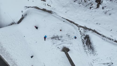 Snowy Fun: Family Sledding in Winter Mountains