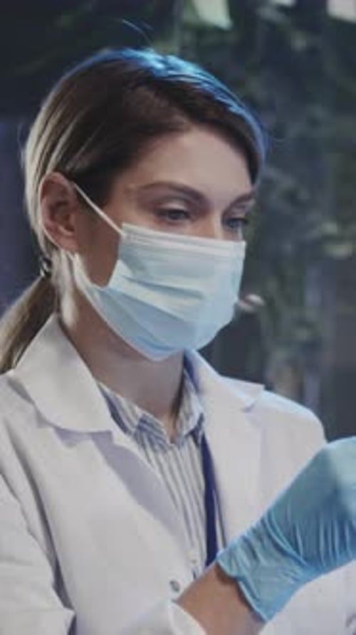 Focused Woman Working in Lab Wearing Face Mask