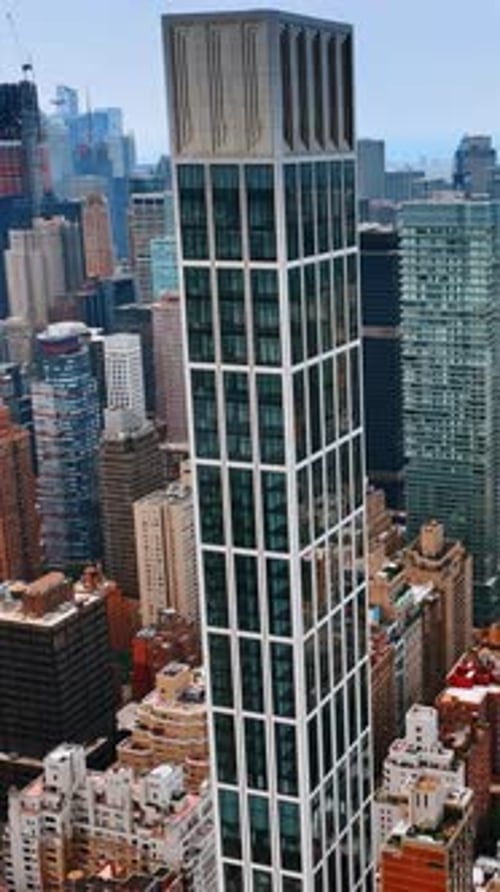 Descending footage above the stunning Manhattan skyscrapers at daytime.