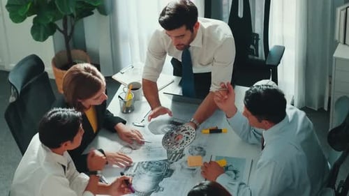 Team Discussing Mechanical Component in Bright Office
