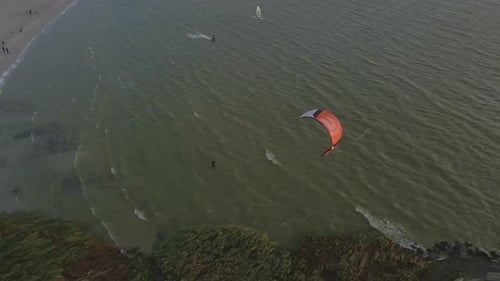 Aerial view of kitesurfing on the sea during sunset, Netherlands
