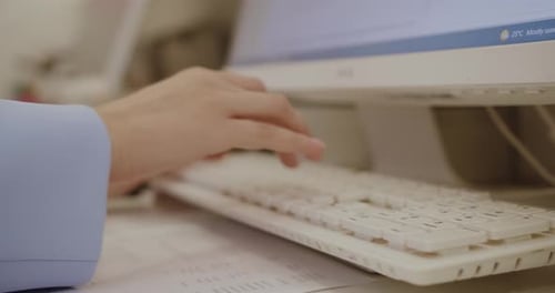 Female hand typing on keyboard on computer, closeup