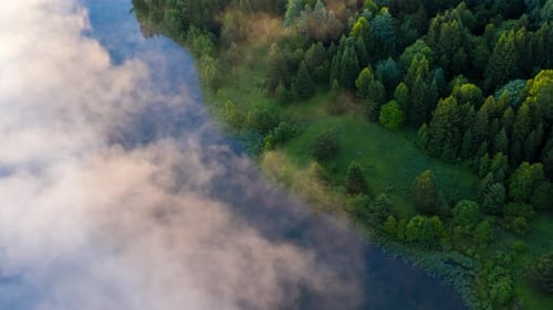 Fog on lake timelapse. Aerial timelapse of the lake with morning fog forming over the water surface