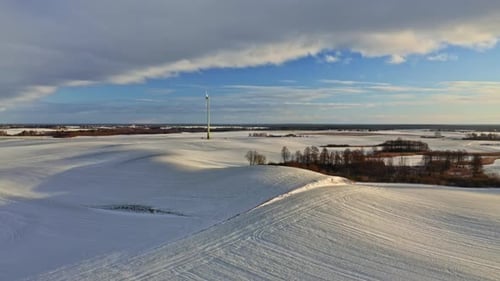 Alternative energy in cold winter. Wind turbine in winter.