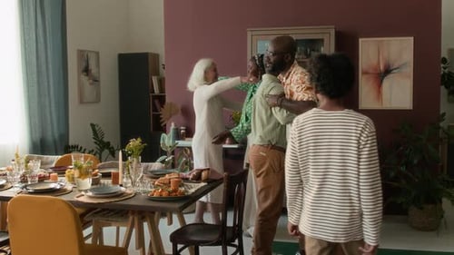 Senior Couple Coming for Holiday Lunch and Hugging Every Family Member