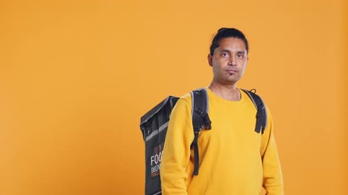 Portrait of Smiling Man Holding Thermal Backpack Studio Background