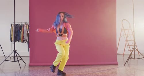 Portrait of happy caucasian female dancer dancing in dance studio, slow motion