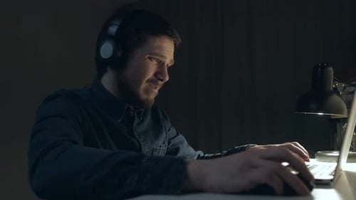 Man is Playing Emotional on Table at Home in Night