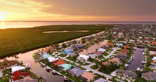 Evening Light Over Florida Waterfront Community Expensive Homes and Luxury Mansions Illuminated By