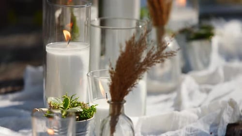 Wedding Party Banquet Outdoors in Forest Dining Table Decorated in Boho Style with Candles White