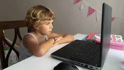 Caucasian Child School Boy or Girl Studying at Home Using Laptop Remote Education in Room