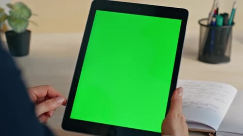 Woman Uses Tablet with Green Screen at Desk