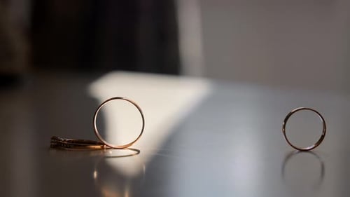 Gold Wedding Rings Touching on Table