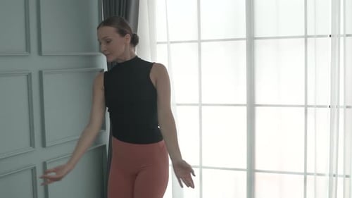 Friends practice ballet dance at studio.