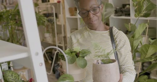 Mature Woman Shopping for Potted plants in Store