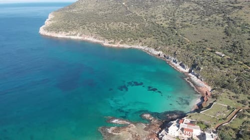 Aerial beautiful beach and water bay in the greek spectacular coast line. Turquoise blue transparent