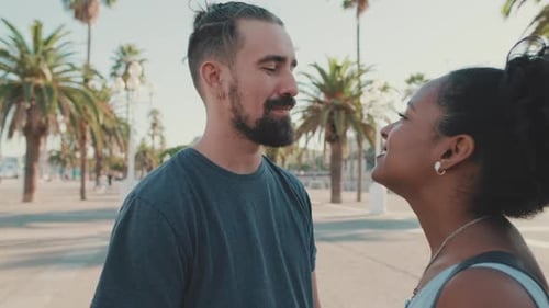 Smiling Couple Embraces on Sunny Urban Day