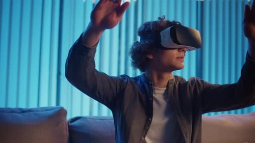 Young Adult Uses Virtual Reality Headset Indoors
