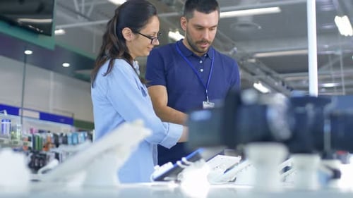 In the Electronics Store Consultant Gives Professional Advice to a Young Woman, She Considers Buyin