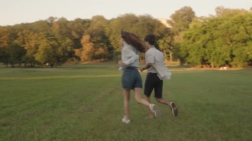 Couple Running Through Park